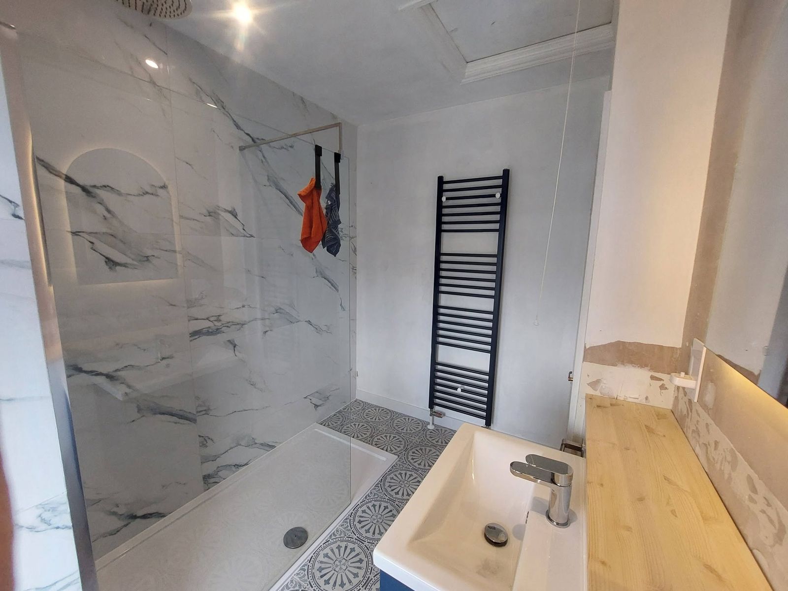 Marble bathroom with black towel rail
