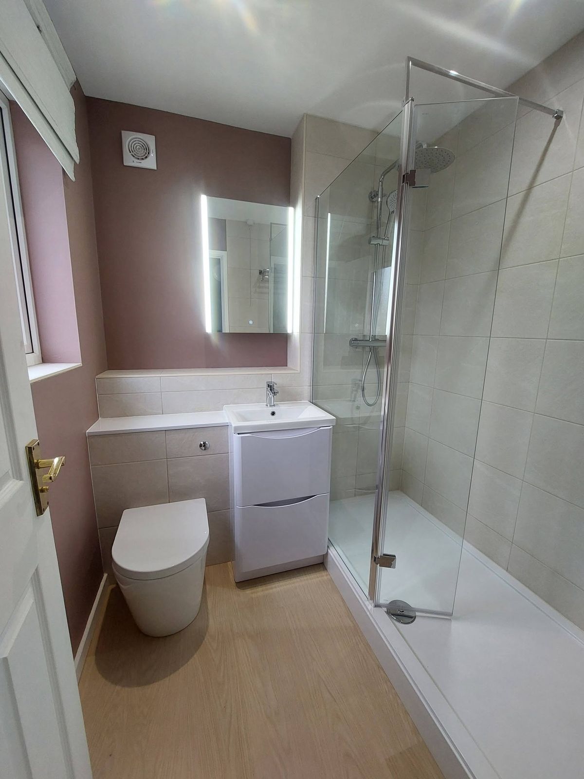 Walk-in shower, blush walls, white vanity